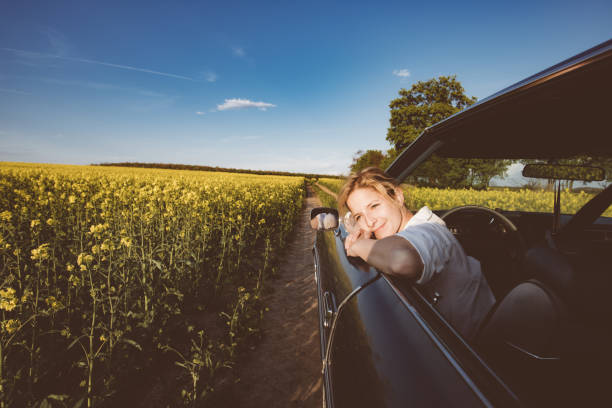 Beautiful young woman relaxing in car stock photo