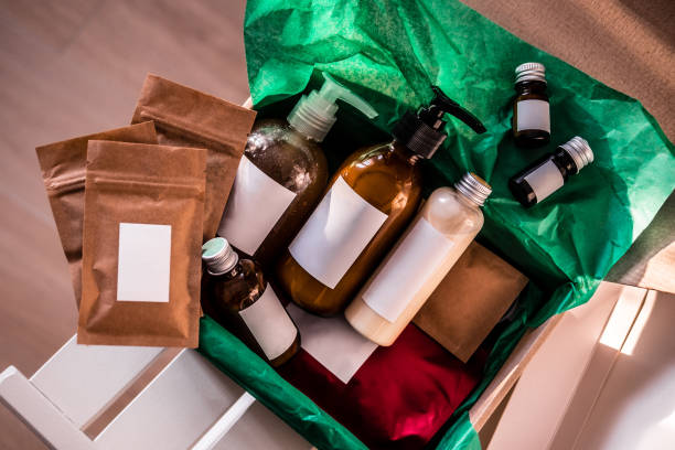 Beauty box with bottles of natural cosmetics Beauty box with bottles of natural cosmetics, wrapped in green paper. Blogger hair and body care routine, salon treatments. Minimalism cosmetic packaging stock pictures, royalty-free photos & images