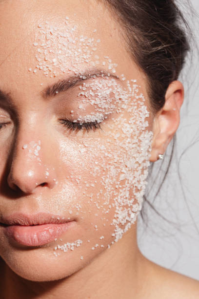 Beauty portrait of a young woman with sea salt over her clean healthy skin stock photo