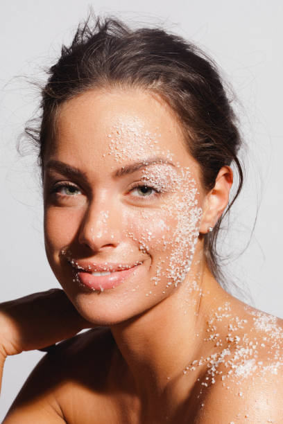 Beauty portrait of a young woman with sea salt over her clean healthy skin stock photo