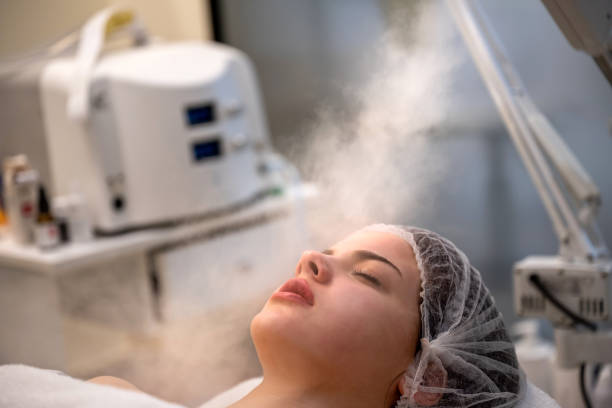 Beauty treatment of face with ozone facial steamer in beauty salon. stock photo
