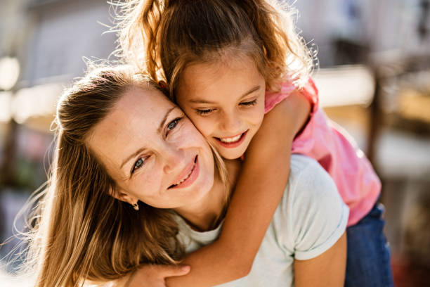 Beauty women carry small girl on the back Portrait young women and cute girl hugging mother and child stock pictures, royalty-free photos & images