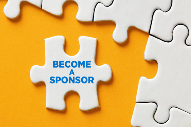 Become a sponsor message on a puzzle piece apart form the assembled pieces. Financial sponsorship support or charity donation stock photo