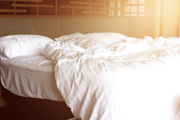bed sheet mess with sun stock photo