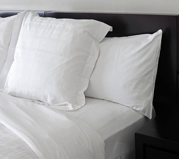 Bed WIth White Pillows stock photo