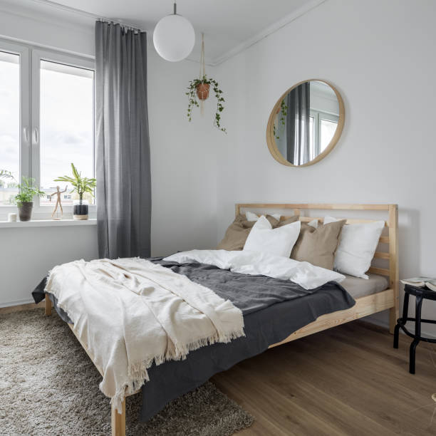 Bedroom with wooden bed Bedroom interior with wooden bed, gray window curtains and mirror scandinavian culture photos stock pictures, royalty-free photos & images