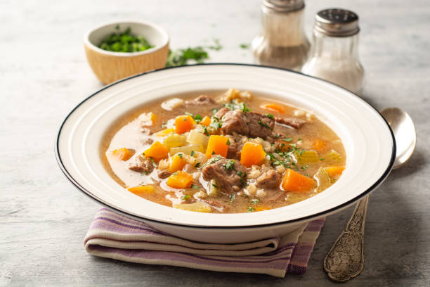 Beef and barley soup with celery, carrot and onion stock photo