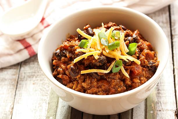 Beef chili with kidney beans and cheese topping stock photo