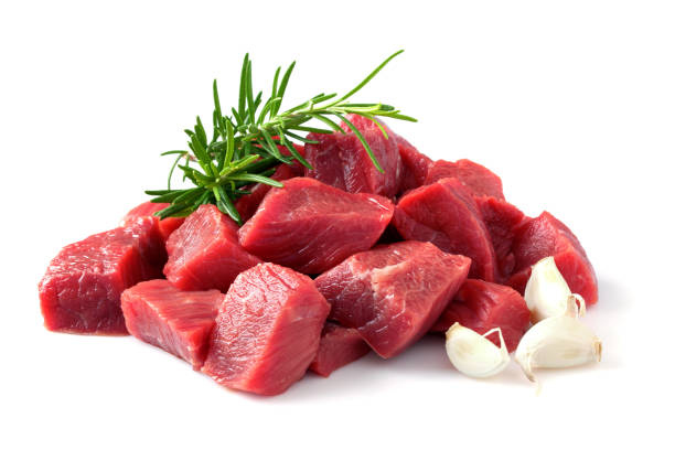 Beef meat cubes with rosemary herb and garlic stock photo