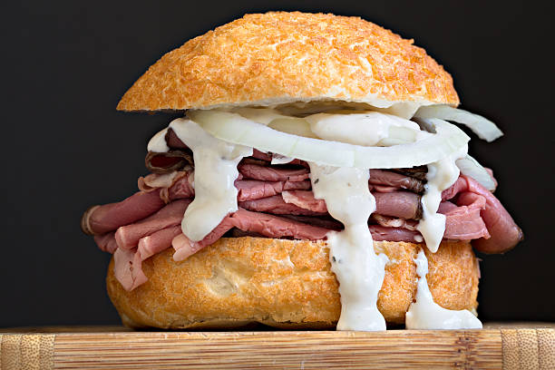 Beef Sandwich On A Kaiser Roll An extreme close up shot of a roast beef sandwich on a kaiser roll. roast beef sandwich stock pictures, royalty-free photos & images