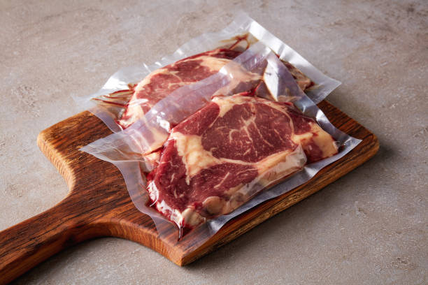 Beef steak vacuum sealed on stone table Beef steak vacuum sealed ready for sous vide cooking airtight stock pictures, royalty-free photos & images