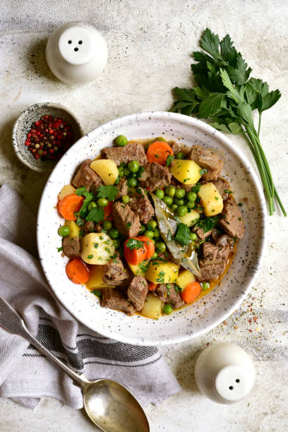 Beef stew with vegetables in a white bowl stock photo