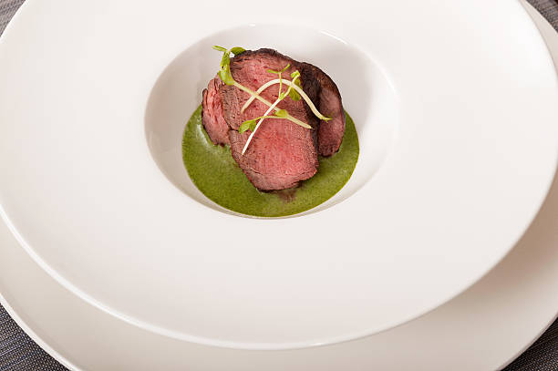 Beef with green sauce Beef with green sauce on a white dish buffalo shooting stock pictures, royalty-free photos & images