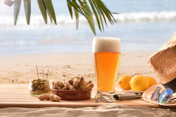 Beer and snack on wood on a beach on holiday stock photo