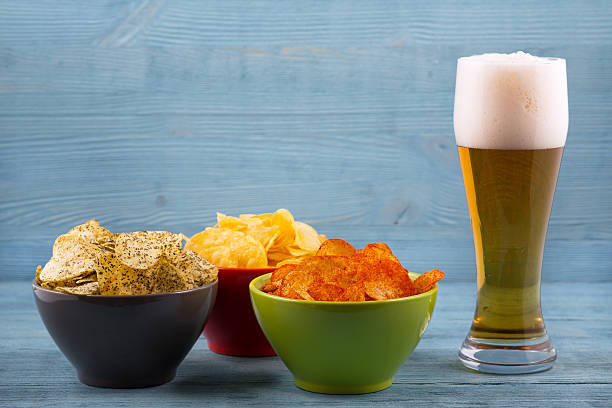 Beer and various types of chips stock photo