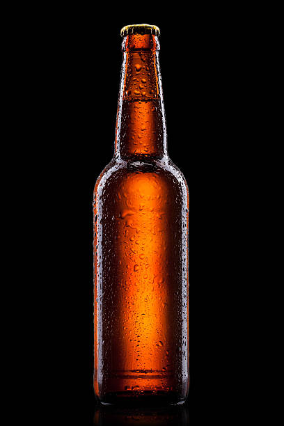 Beer bottle with water drops isolated on black stock photo