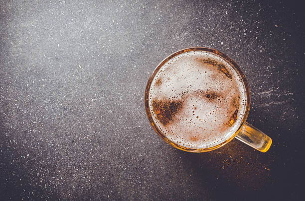 Beer glass on dark table stock photo