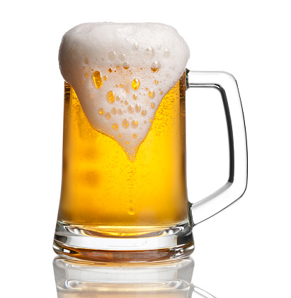 photographed overflowing beer mug with a bit of condensation. clipping path included. View more drinks