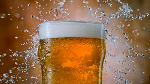 Beer glass with splashing water stock photo