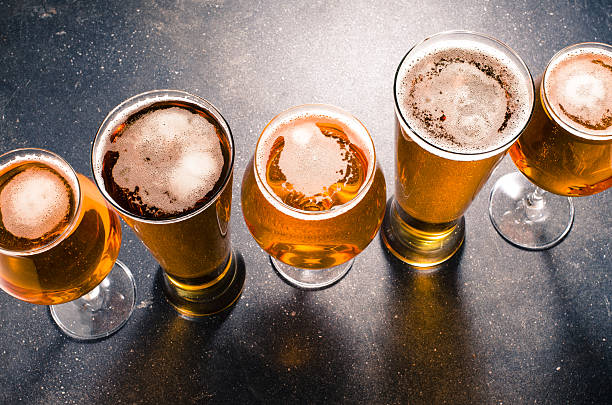 Beer glasses on dark table stock photo
