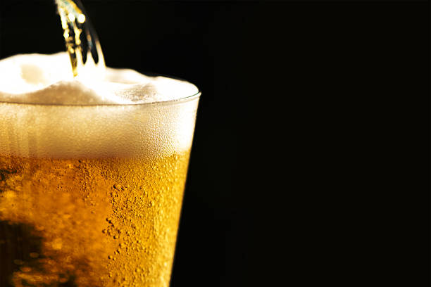 Beer into glass stock photo