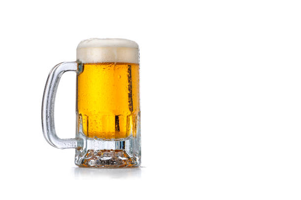 Beer mug on white background. Copy space Front view of a beer mug isolated on white background. The mug is cold and condensation drops are visible on it. The composition is at the left of an horizontal frame leaving useful copy space for text and/or logo at the right. High resolution 42Mp studio digital capture taken with Sony A7rII and Sony FE 90mm f2.8 macro G OSS lens beer glass stock pictures, royalty-free photos & images