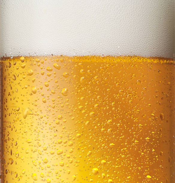 Beer Fresh beer with froth and condensed water drops (Close-up) foam material stock pictures, royalty-free photos & images