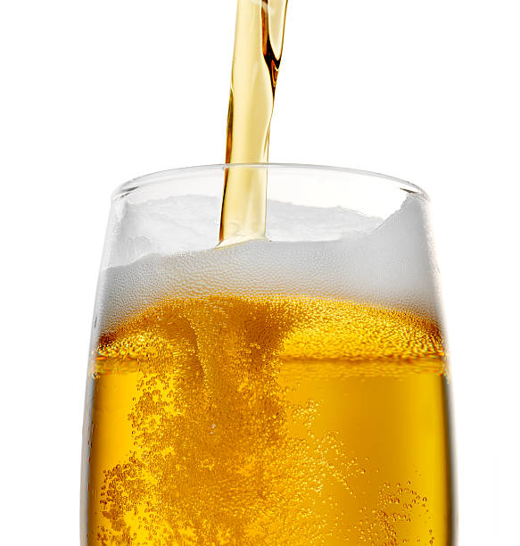 Beer Pouring beer into a glass on white background (+ clipping path) pouring stock pictures, royalty-free photos & images