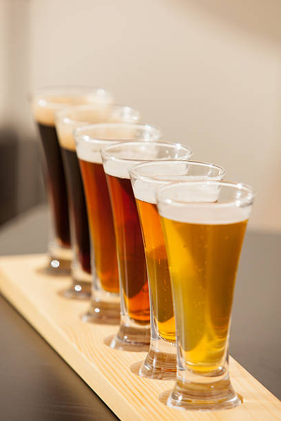 Beer samplers lined up on a bar. stock photo