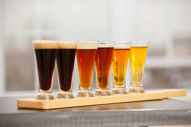 Beer samples lined up on a bar. stock photo