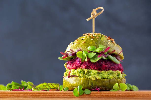 Beet burger on a spinach bread bun stock photo