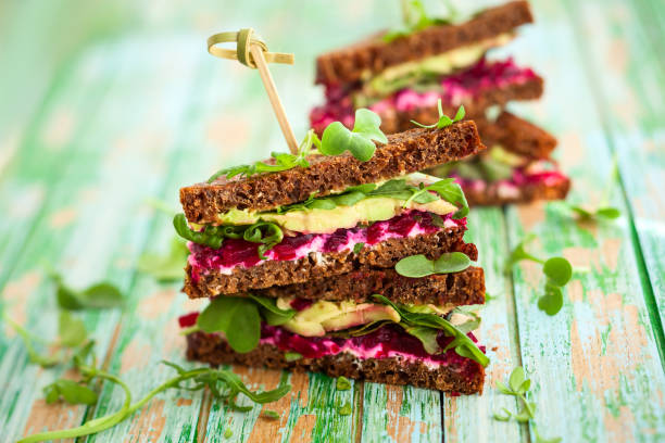 beet,avocado and arugula sandwich stock photo
