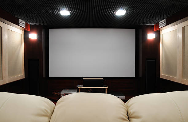 Behind the couch point of view of home theater setting soundproof home theater in home cellar with clean canvas for any contents soundproof stock pictures, royalty-free photos & images