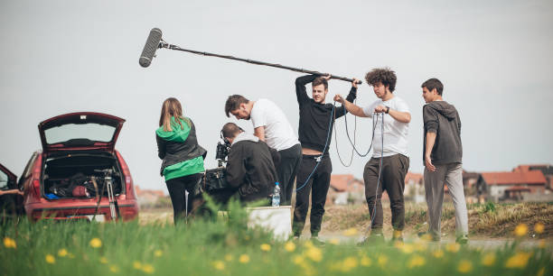 Behind the scene. Film crew filming movie scene outdoor Behind the scene. Film crew team filming movie scene on outdoor location. Group cinema set actress stock pictures, royalty-free photos & images