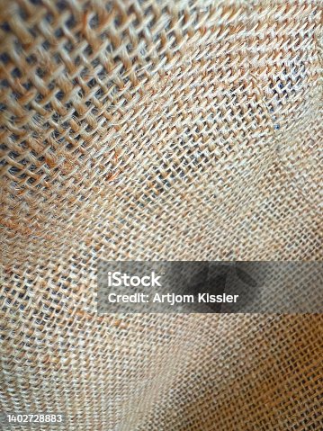 istock A beige and coarsely braided fabric as a texture or background. 1402728883