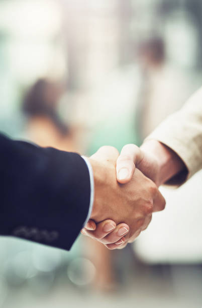 Shot of businesspeople shaking hands in an office