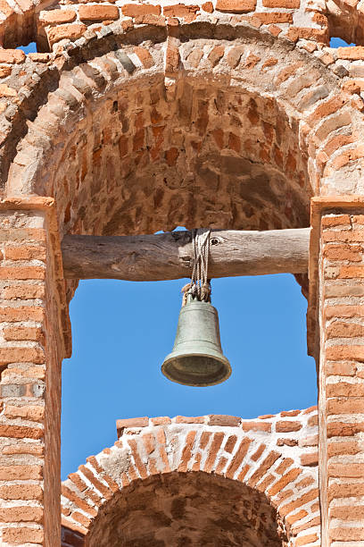 Bell Tower on the Mission San Jose de Tumacacori Tumacácori National Historical Park in the upper Santa Cruz River Valley consists of 360 acres in three separate units and protects the remains of three Spanish mission communities. The Mission San José de Tumacácori was built in the 1750s. By 1848, the mission was abandoned and began falling into disrepair. After the Gadsden Purchase of 1854, this area became a part of the Arizona Territory. In 1908 the site was declared Tumacácori National Monument by President Theodore Roosevelt and restoration efforts began. The site was listed on the National Register of Historic Places on October 15, 1966. In 1990 the national monument became a National Historical Park. This photograph shows the bell tower on the church building. The church and grounds are located in Tumacacori National Historical Park near Tubac, Arizona, USA. jeff goulden church stock pictures, royalty-free photos & images