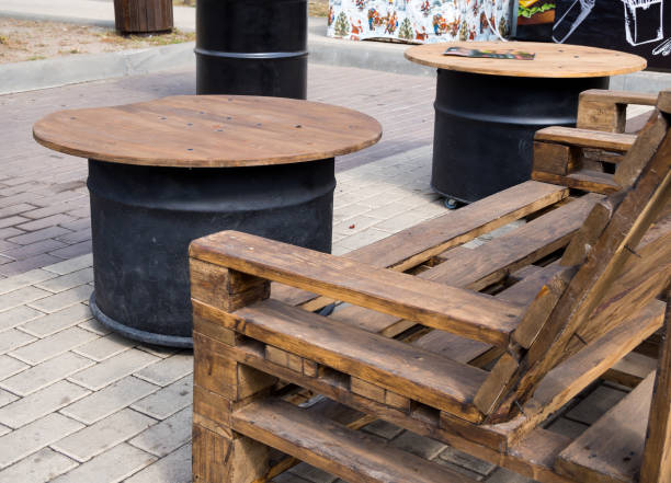 Bench from old pallets and tables from metal drums Bench from old pallets and tables from metal drums upcycling stock pictures, royalty-free photos & images