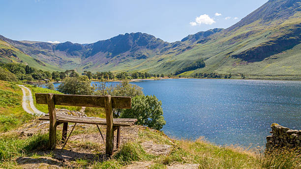 Bench overlooking Buttermere, Cumbria,The Lake District UK Small bench overlooking Buttermere lake in  Cumbria, The Lake District UK english lake district stock pictures, royalty-free photos & images