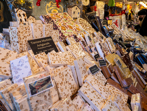 Bergamo, Italy. View of the Christmas market in the city center. Stalls selling different types of nougat and sweets