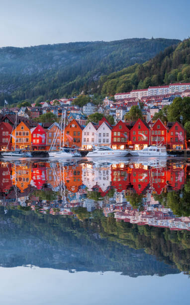Bergen street at night with boats in Norway, UNESCO World Heritage Site stock photo