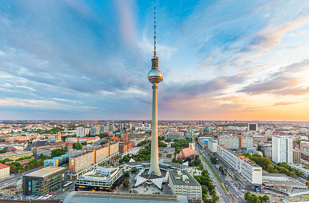 Berlin skyline panorama with TV tower at sunset, Germany Berlin skyline panorama with famous TV tower at Alexanderplatz and dramatic cloudscape at sunset, Germany. central berlin stock pictures, royalty-free photos & images