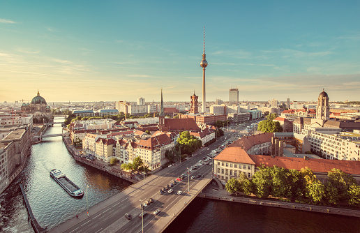 Aerial view of Berlin skyline with famous TV tower and Spree river in beautiful evening light at sunset with retro vintage Instagram style grunge pastel toned filter effect, Germany.