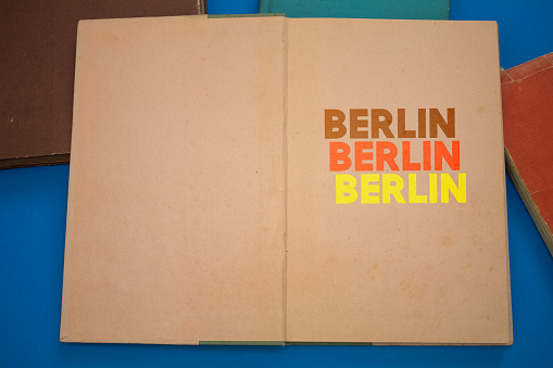 Berlin word in opened book with vintage, natural patterns old antique paper design.
