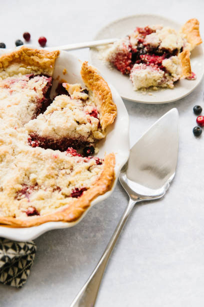 A Berry pie and two slices stock photo