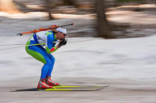 Biathlon competitor at downhill stock photo