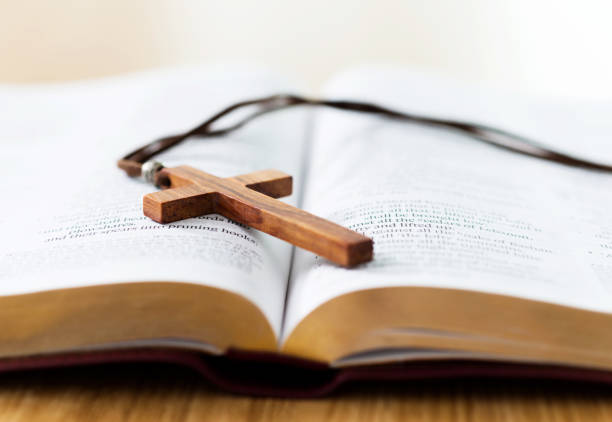 Bible and cross on desk Bible and cross on desk. christianity stock pictures, royalty-free photos & images