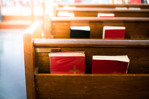 bible at church Bibles in wooden bench compartment in church, church service for Christian church stock pictures, royalty-free photos & images