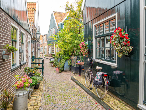 Bicycle in small street Kerkepad in Volendam, Noord-Holland, Netherlands stock photo