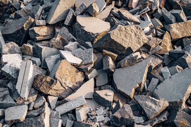 Big and small pieces of stones covering the ground. Boulders with flat sides lying in the heap. Granite stones close up. stock photo